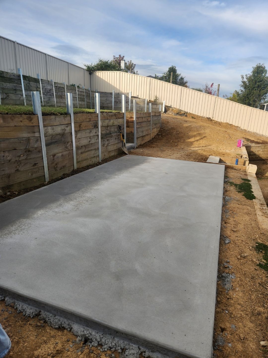 A Construction Worker Is Pouring Concrete Into A Rebar Mesh — Regional Concreting Solutions In Blayney, NSW