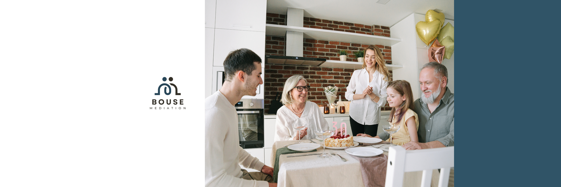 A multi-generational family sitting together at a dining table for a meal, with a logo on the left side.