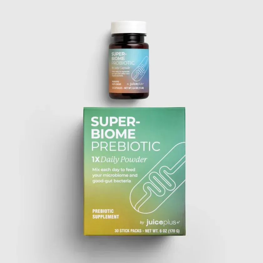 A bottle and box of Juice Plus Super-Biome probiotic and prebiotic supplements, with a light blue and green gradient.