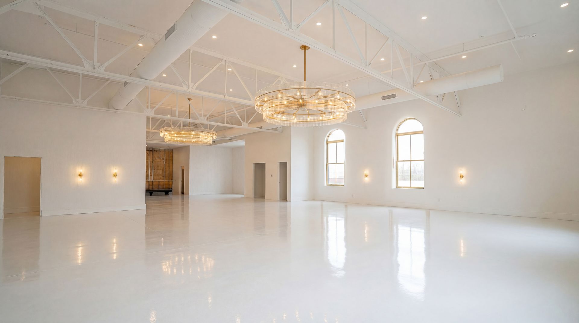 Empty wedding hall at Casablanca with gold chairs and benches. Large chandelier hangs from white ceiling.