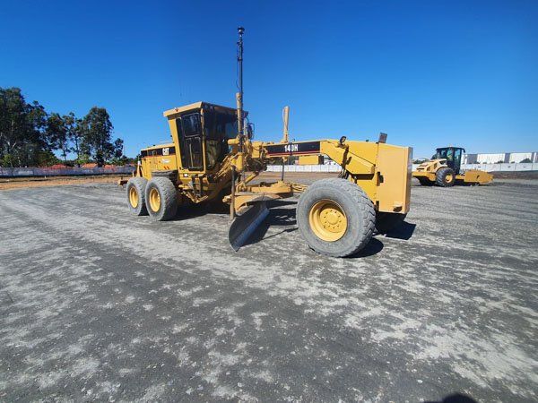 Road grader working on road construction services