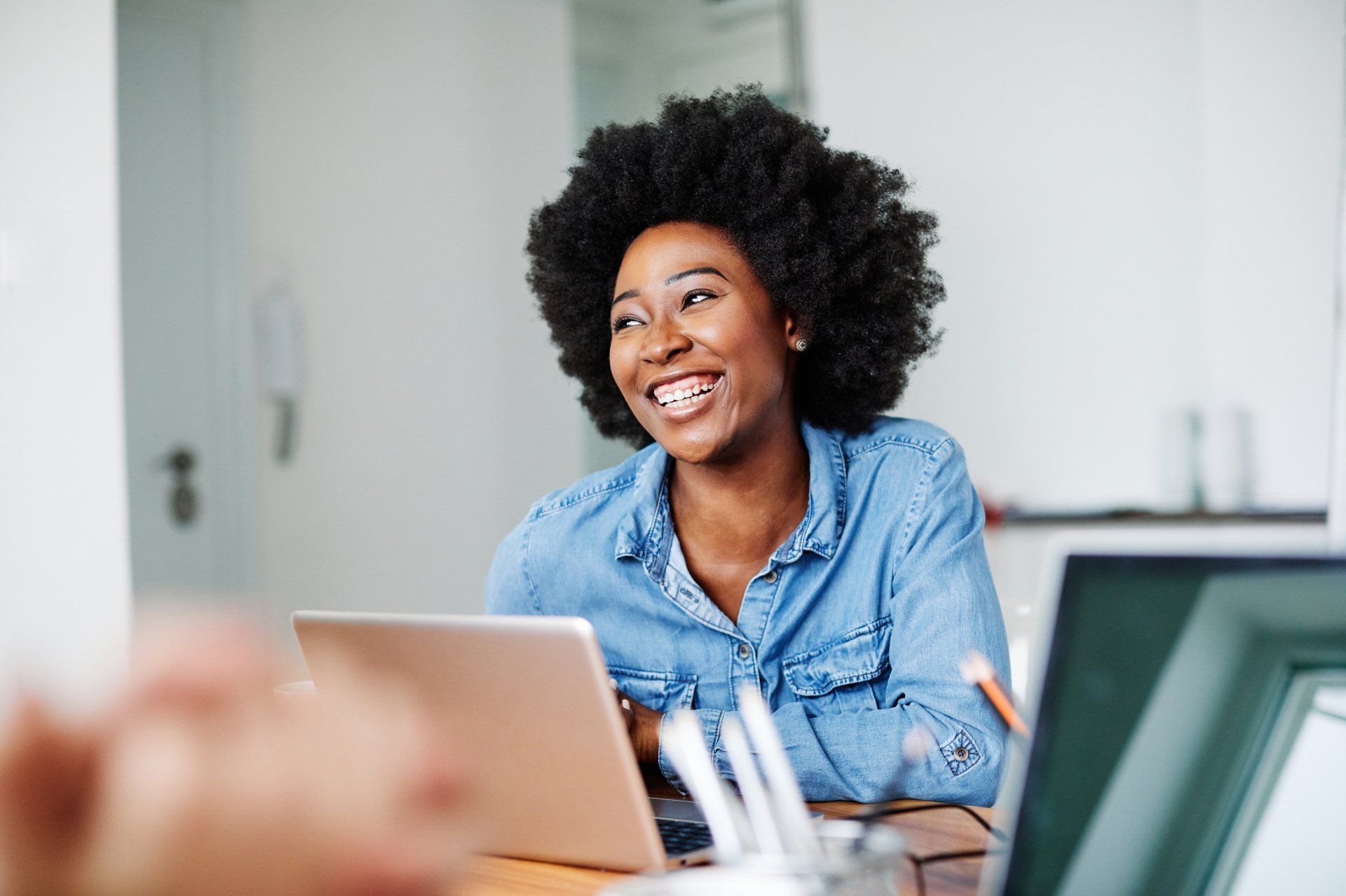 Professional black woman smiling at her desk after a successful website audit