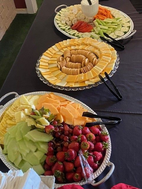Group of children standing on a green golf course, smiling, some with golf attire.