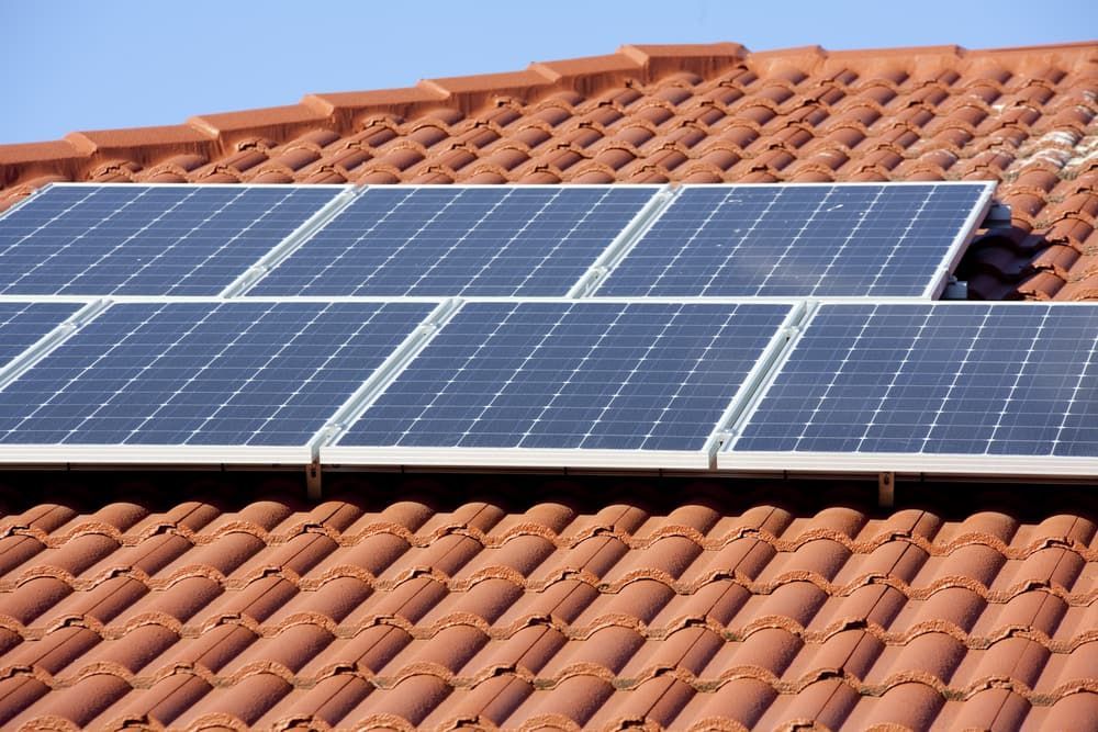 Rooftop Featuring Several Dark Blue Solar Panels — Exquisite Exterior Cleaning In Erina, NSW