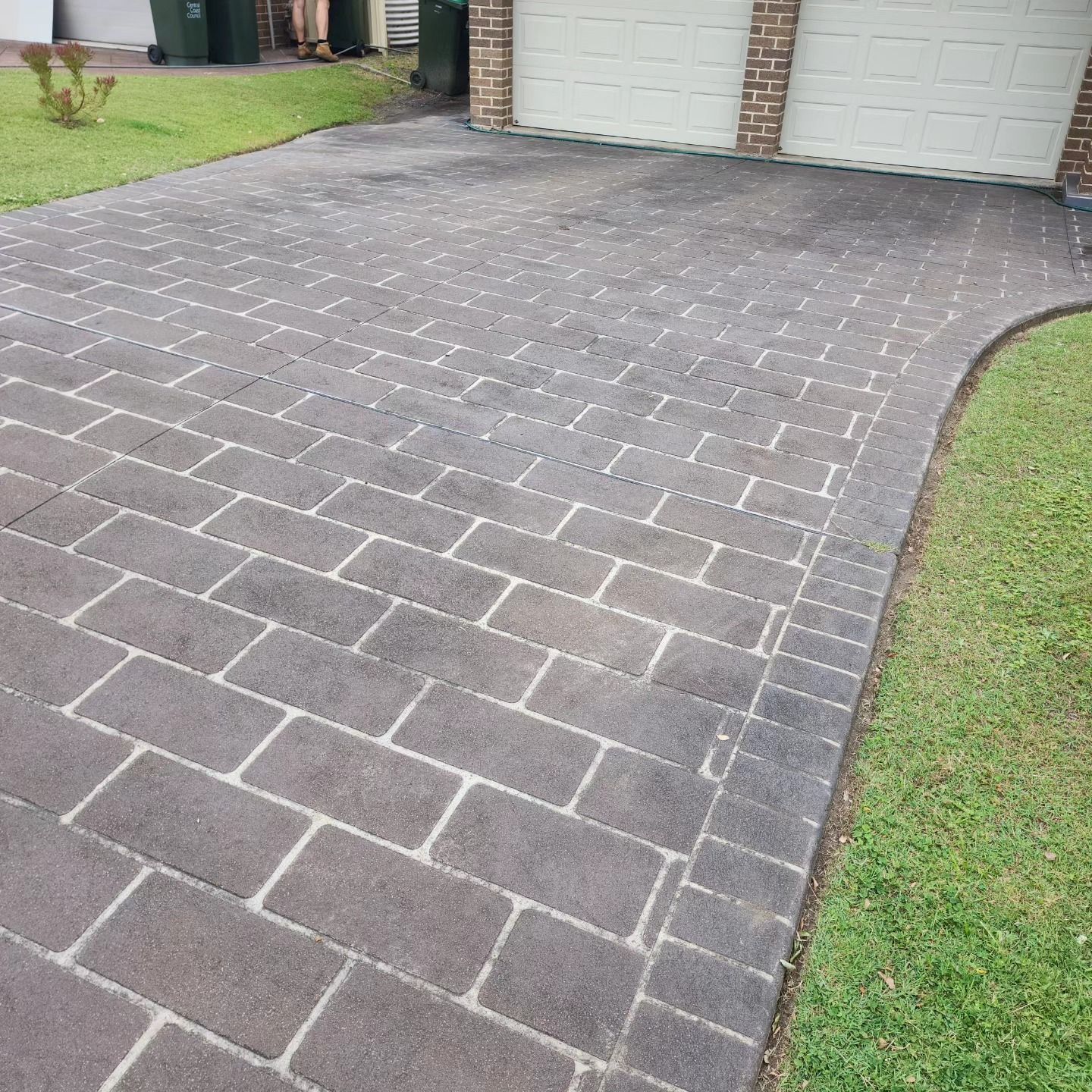 A Paved Brick Driveway Leads to Two Garage Doors — Exquisite Exterior Cleaning in North Gosford, NSW