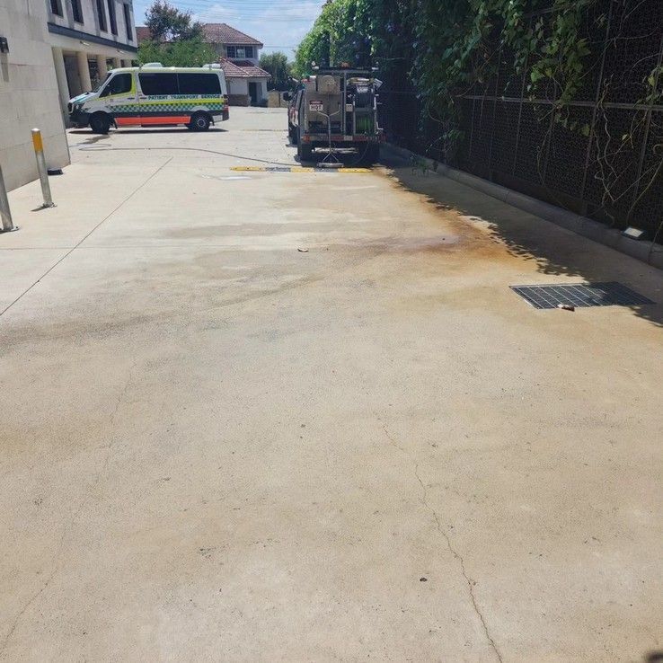 An Ambulance is Parked on the Side of the Road in a Parking Lot — Exquisite Exterior Cleaning In North Gosford, NSW