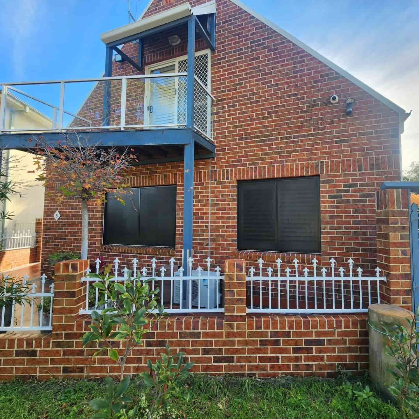 A Brick House With a Balcony — Exquisite Exterior Cleaning In Tuggerah, NSW