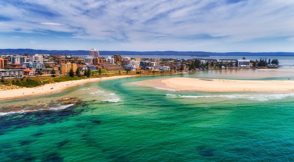 Beach With a City in the Background — Exquisite Exterior Cleaning In Tuggerah, NSW