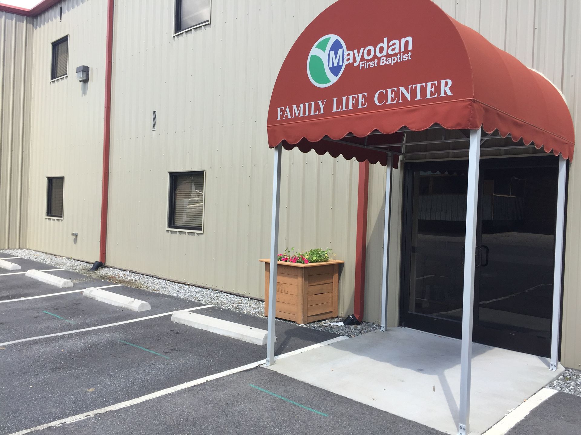 A building with a red awning that says family life center