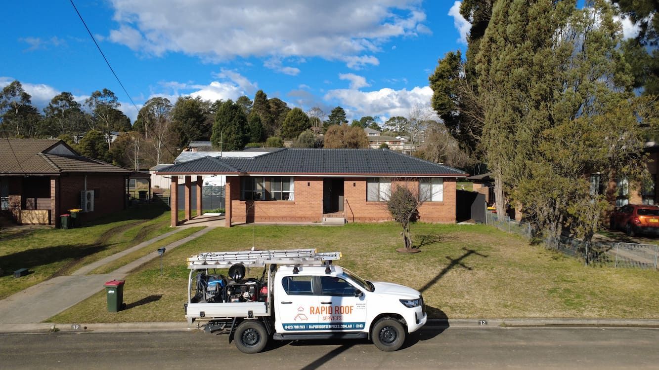 The Rapid Roof Services vehicle in front of a house in Hornsby