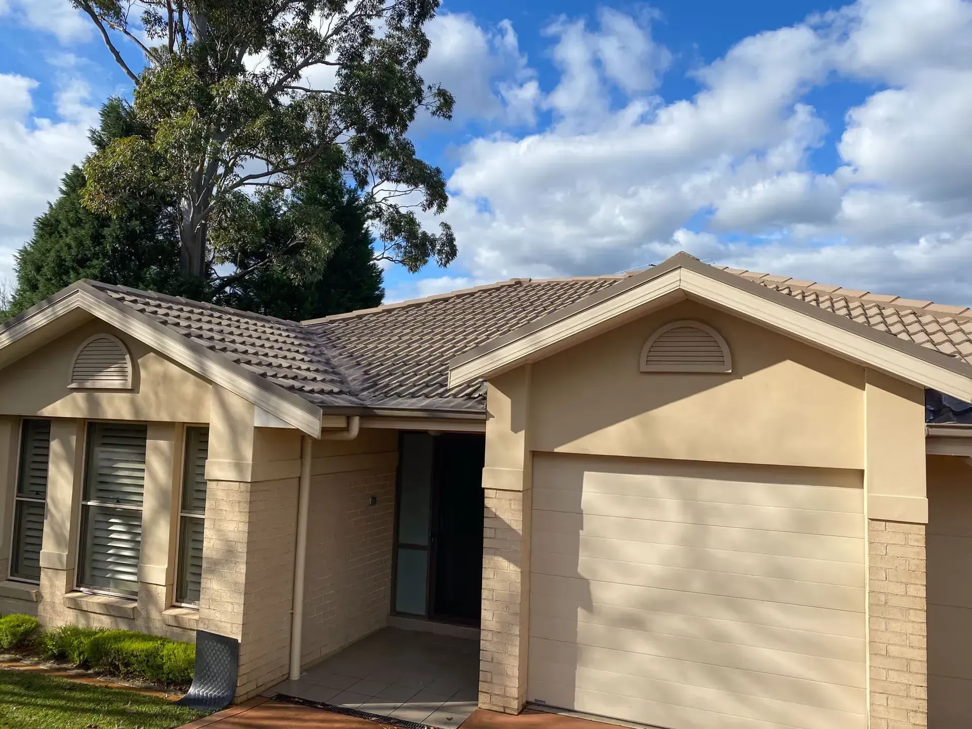 A house with a roof and a garage door