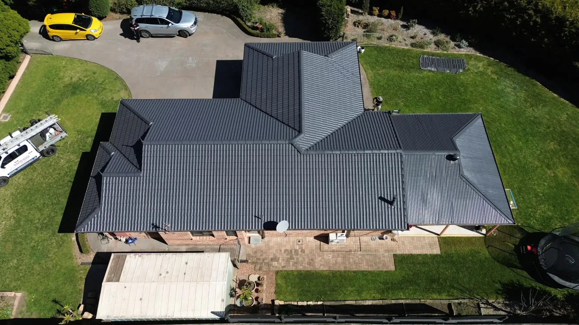 An aerial view of a house with a black roof