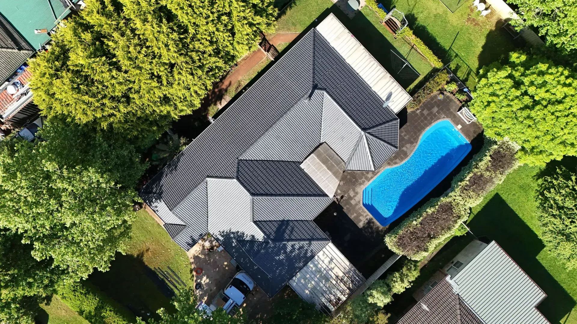 An aerial view of a house with a pool in the backyard