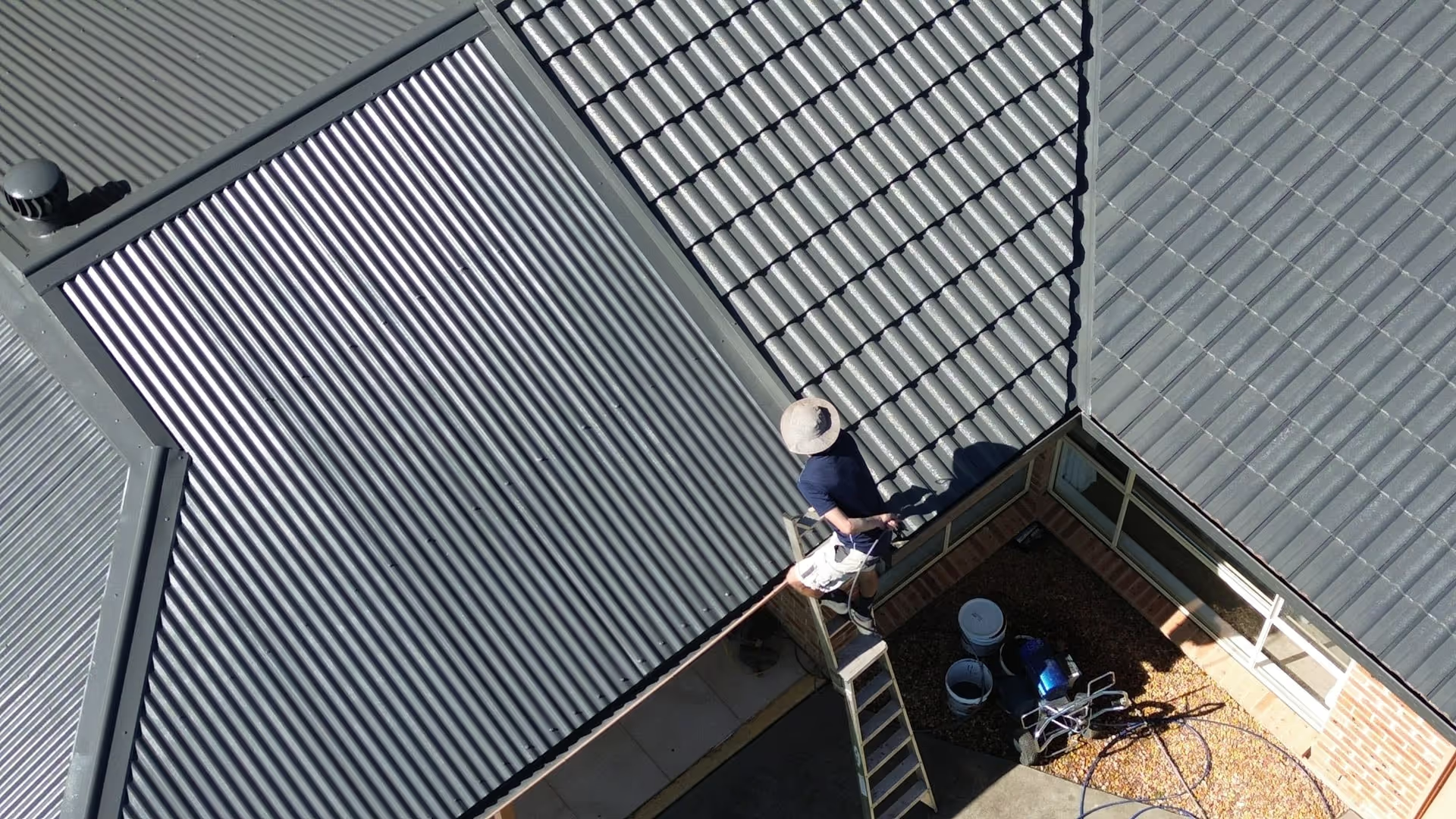 A person painting a roof