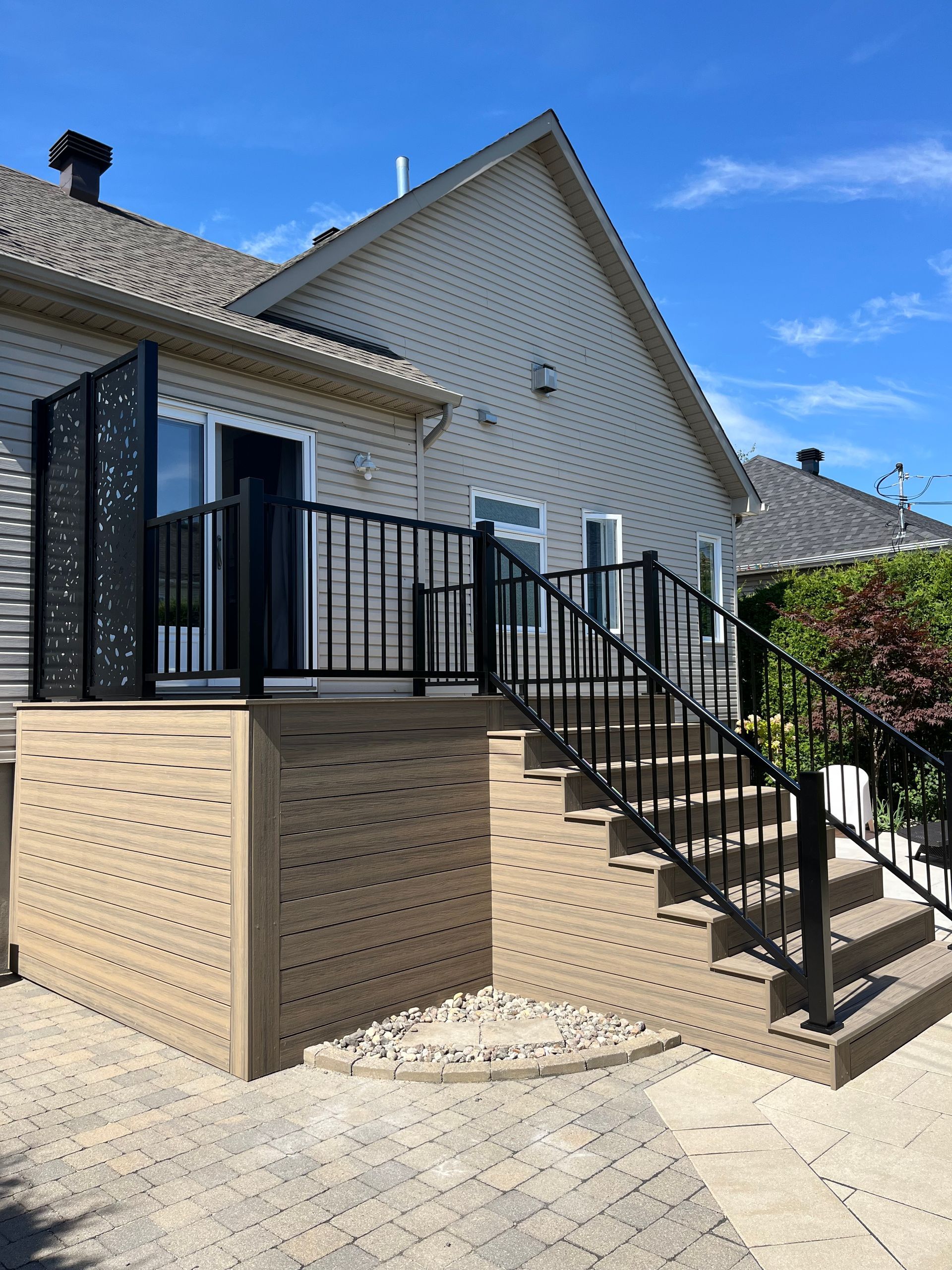 Une maison avec une terrasse et des escaliers qui y mènent