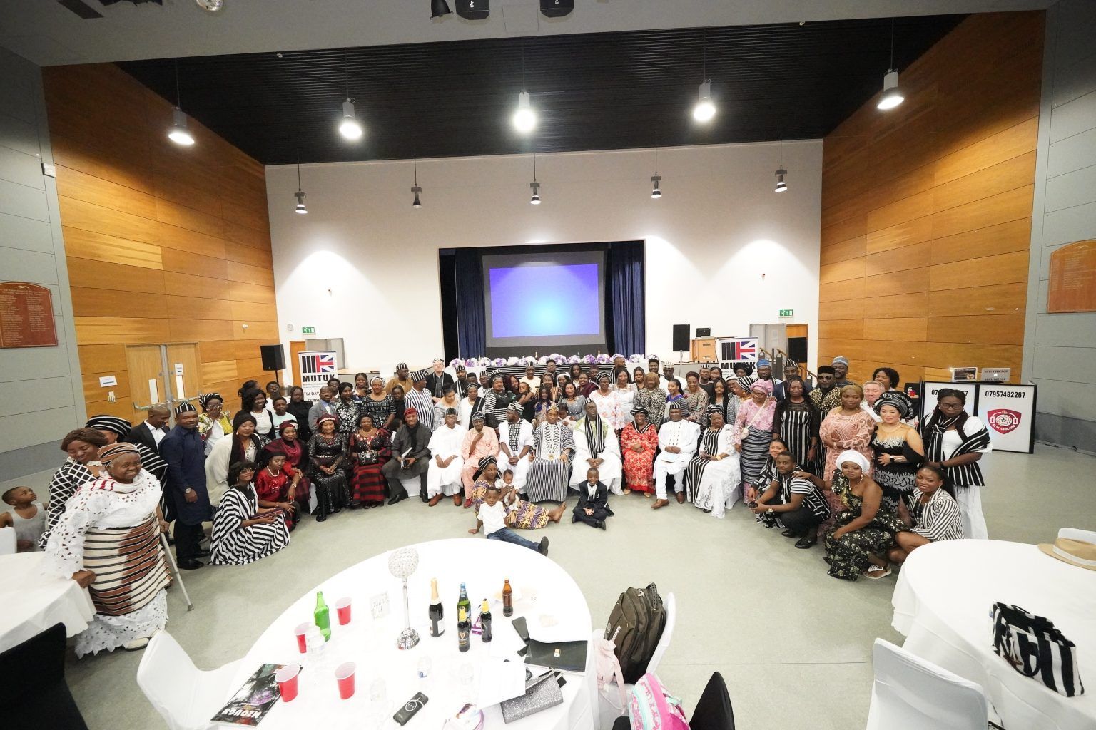 A large group of people are posing for a picture in a large room