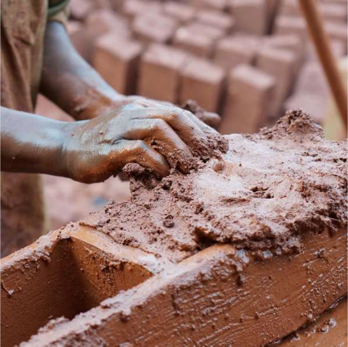 A Building Site Moulding mud bricks