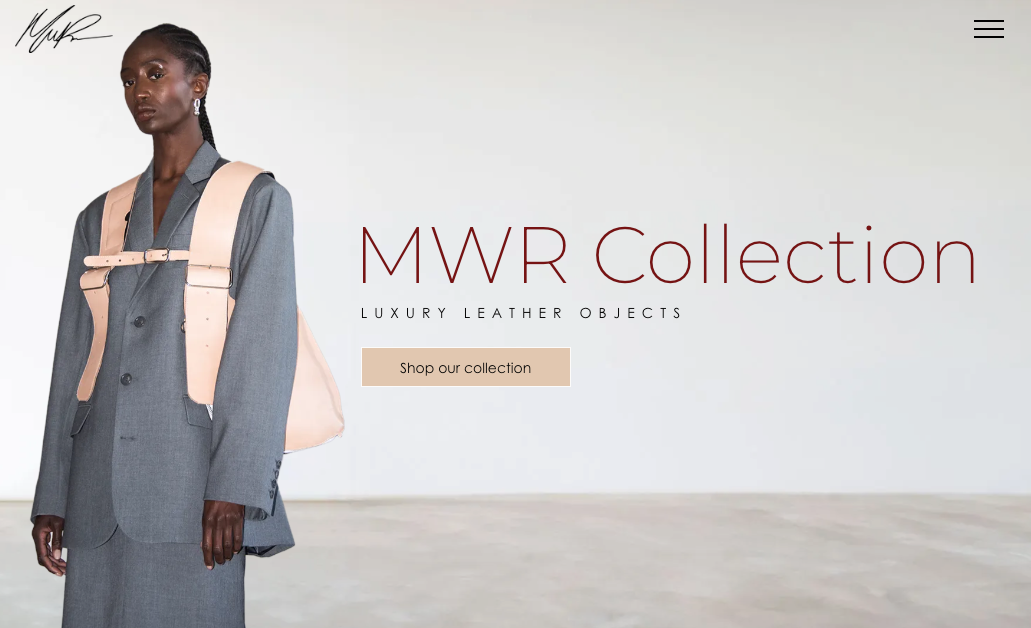 Woman in gray suit and peach harness, MWR Collection displayed, neutral background.
