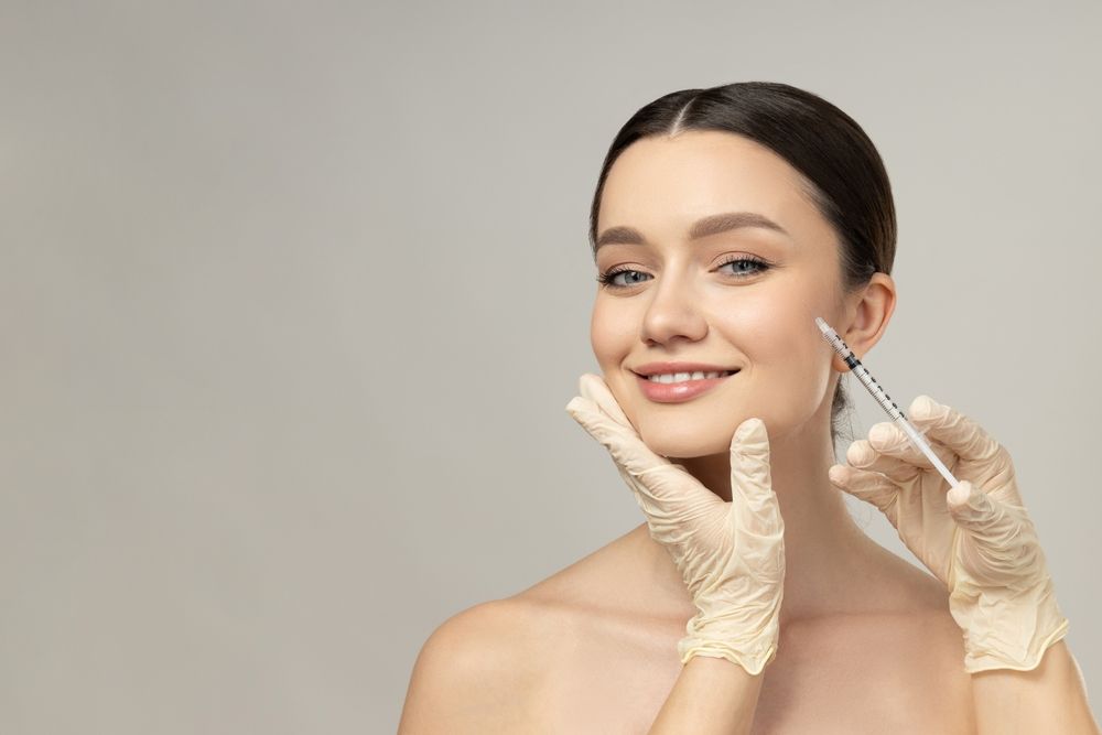 A woman is getting a botox injection in her face.