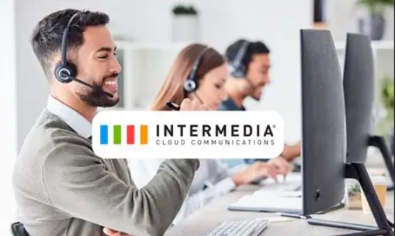 Intermedia Logo and background of users in a call center setting with wireless headsets.