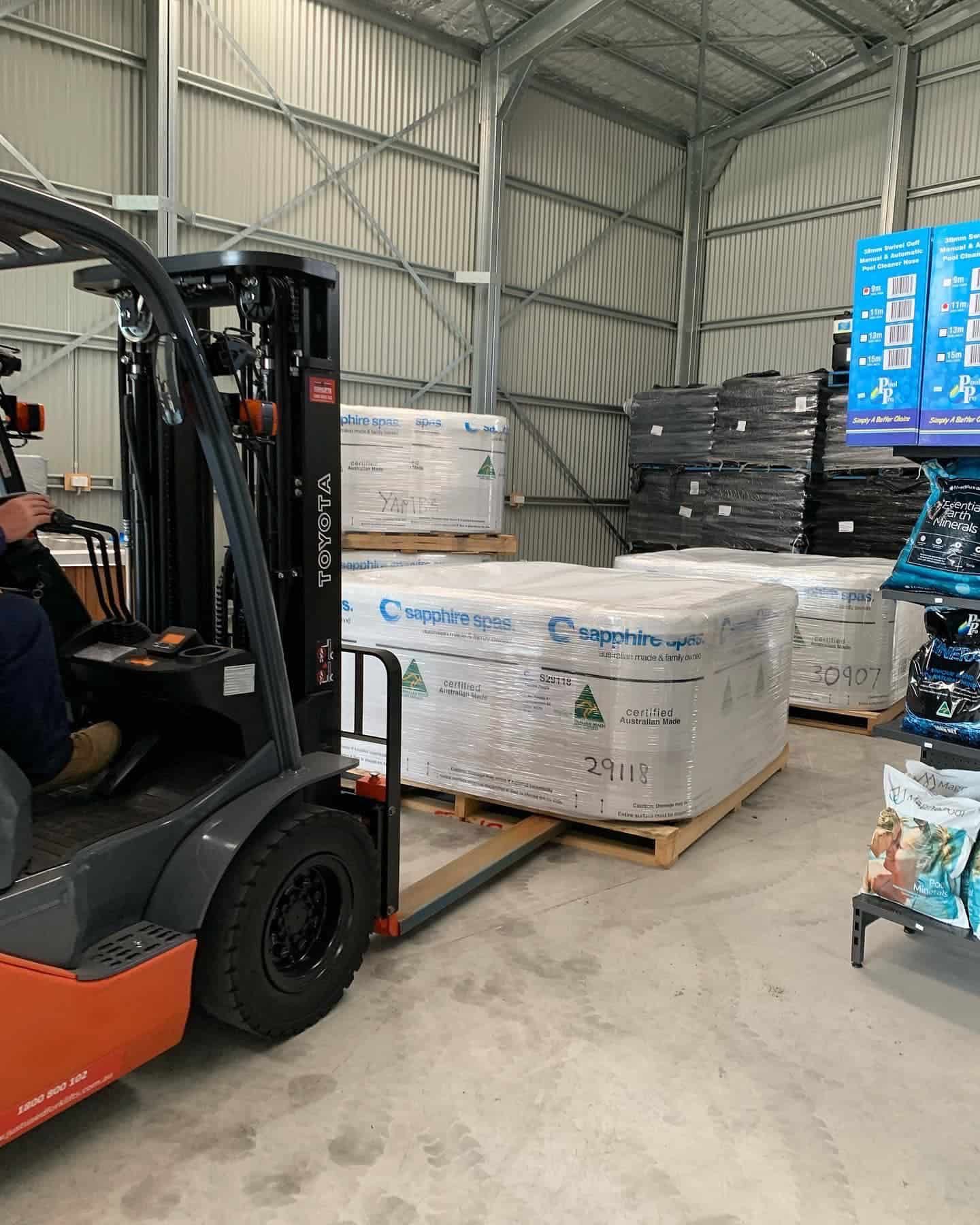 Forklift lifting a Sapphire spa— Yamba Pools & Spas In Yamba, NSW