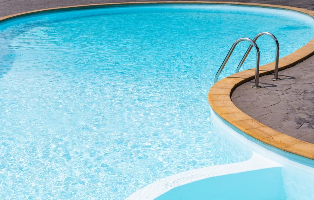 A Large Swimming Pool With Stairs Leading Into It — Yamba Pools & Spas In Townsend, NSW