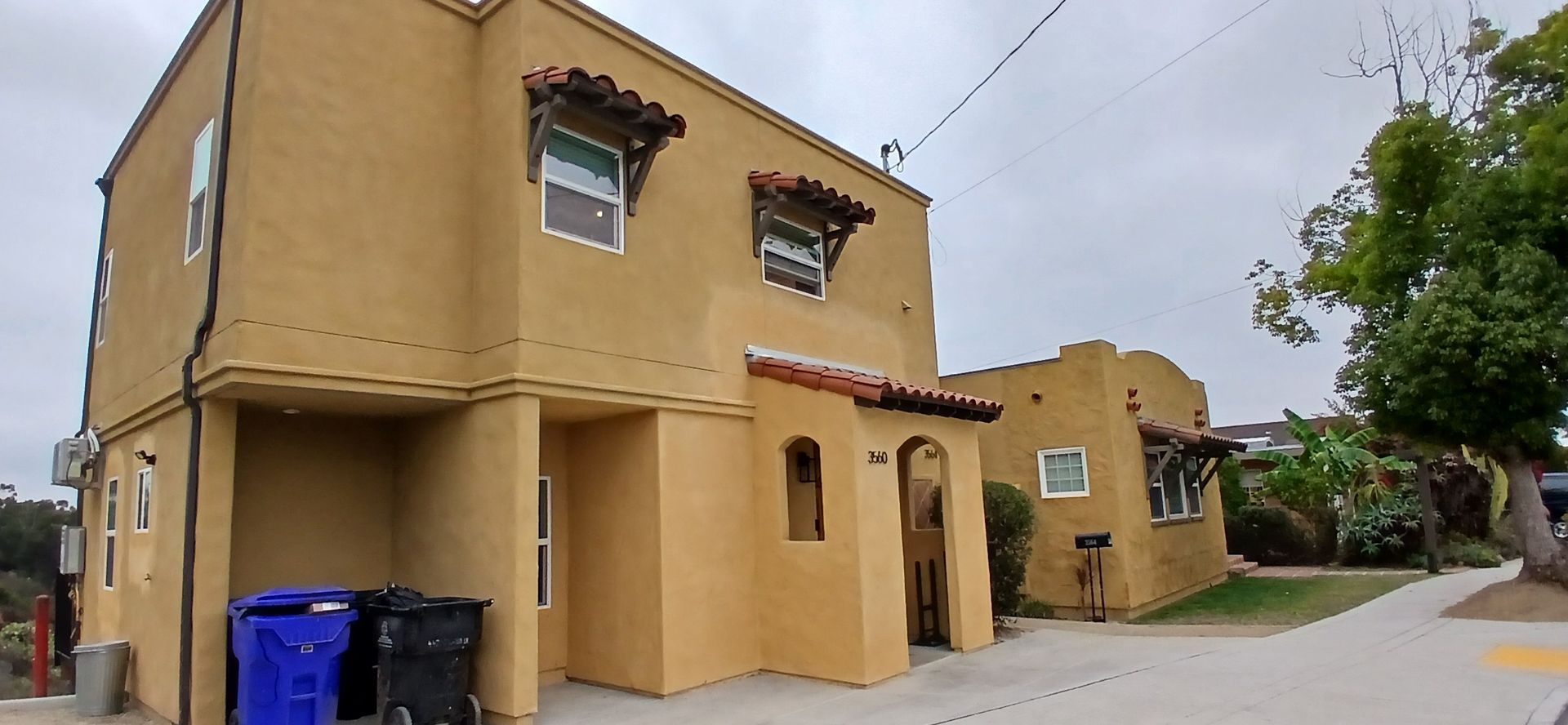 A building with a lot of trash cans in front of it.
