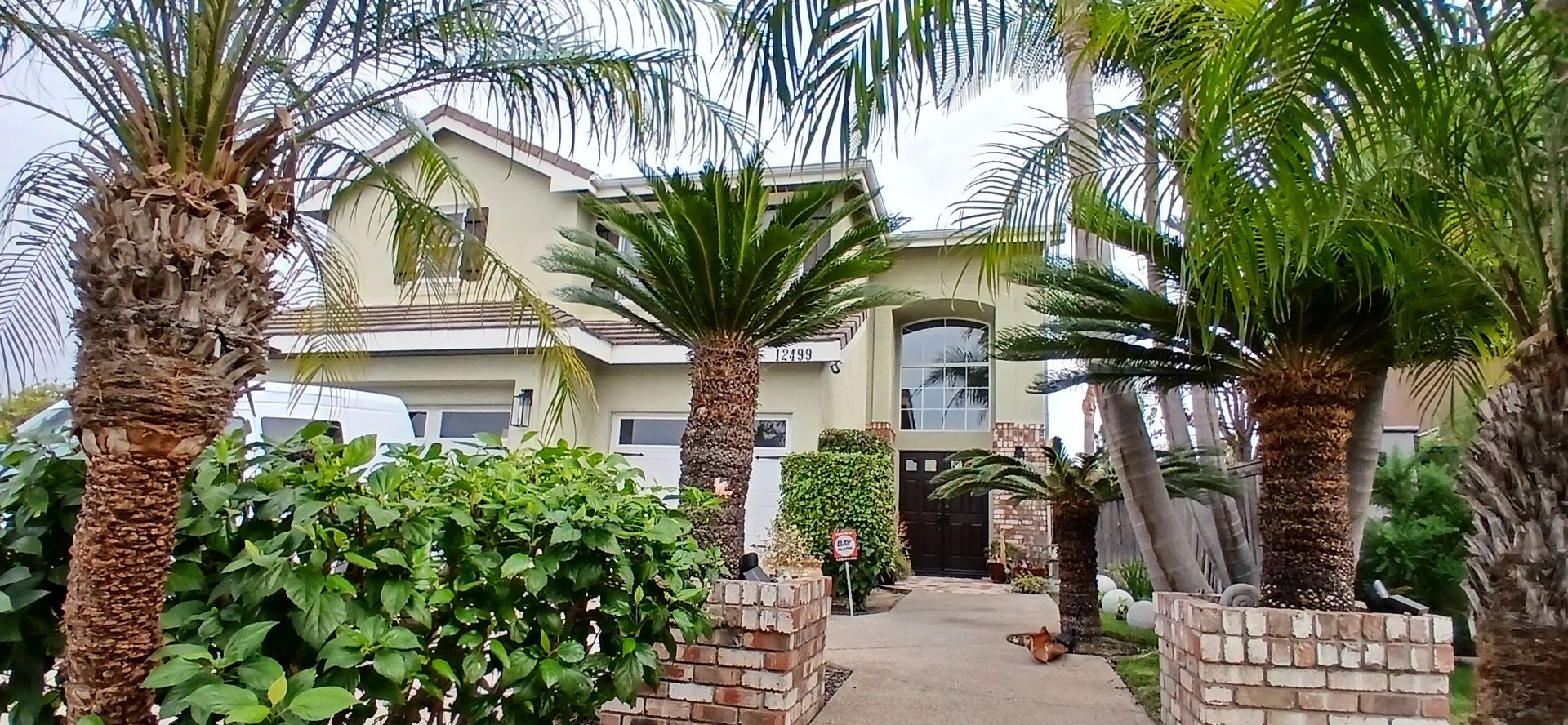 A large house with palm trees in front of it