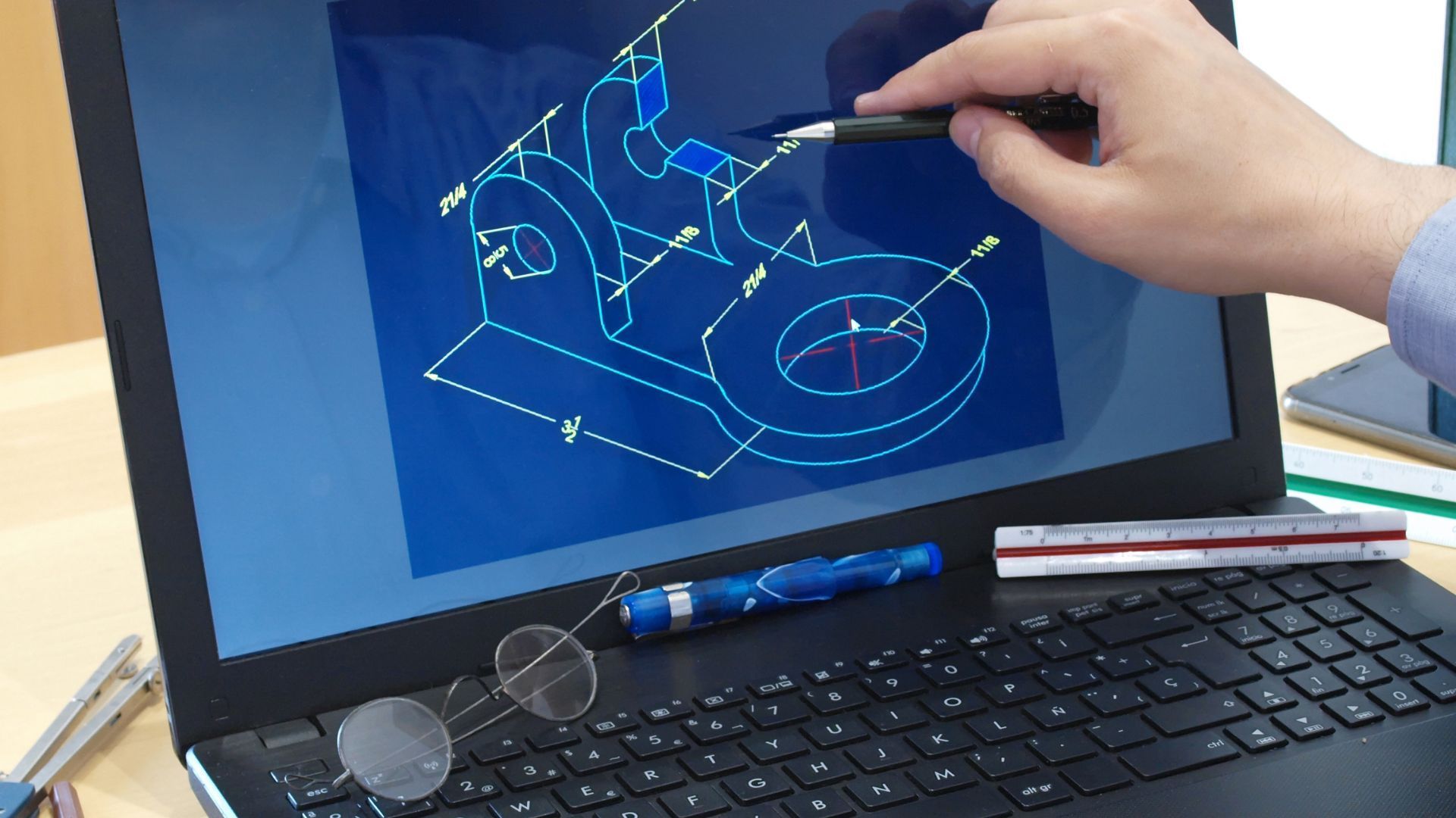 A person is pointing at a drawing on a laptop screen