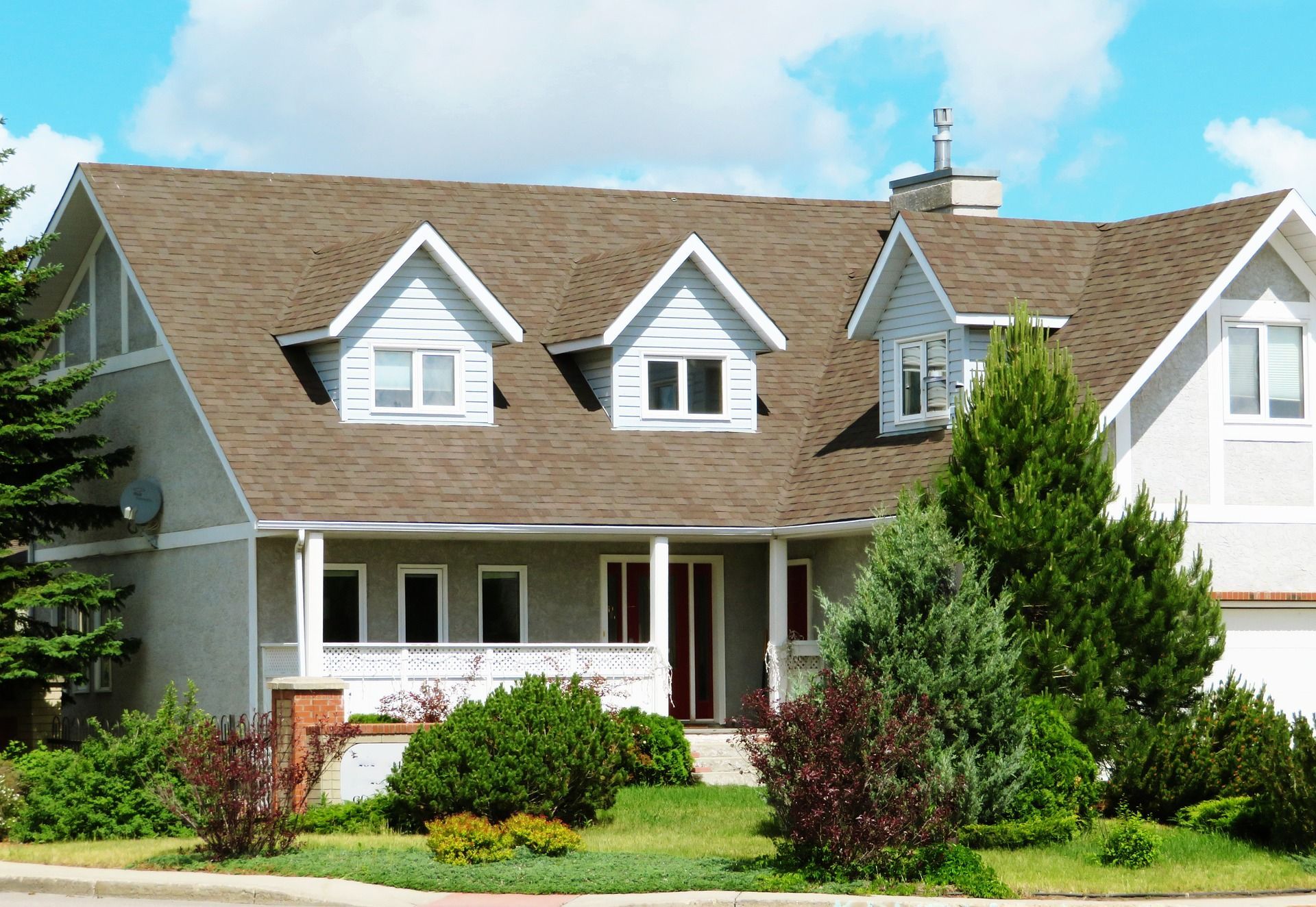 A large white house with a brown roof