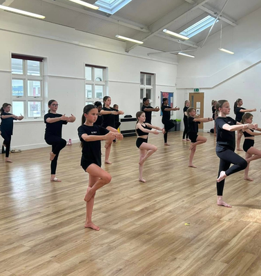 Young energetic dancer performs modern dance pose