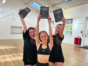 Gymnast waving blue ribbons with high speed motion