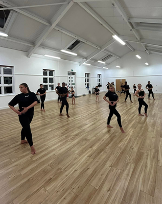 Young energetic dancer performs modern dance pose