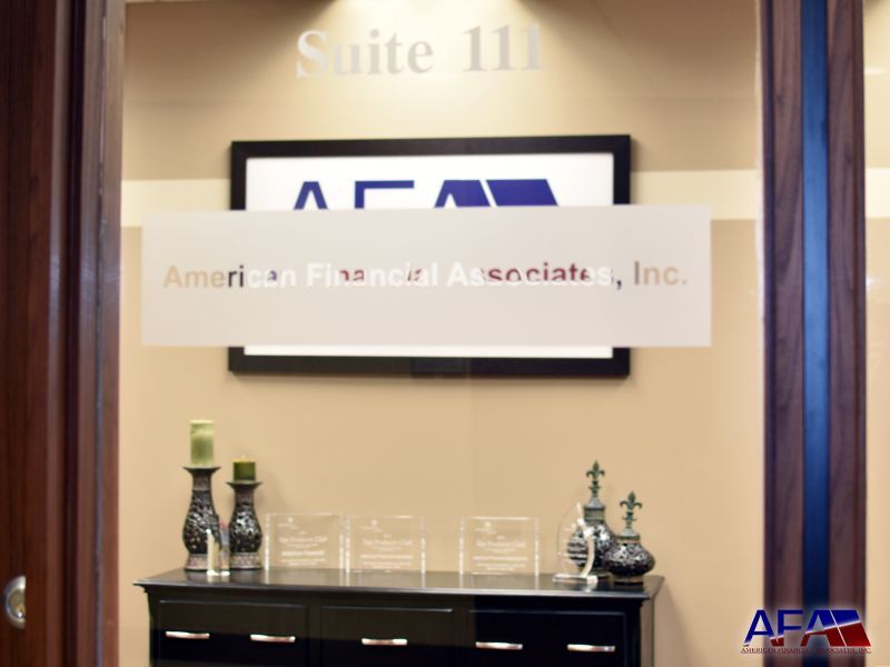 A sign for american financial associates inc. hangs above a dresser