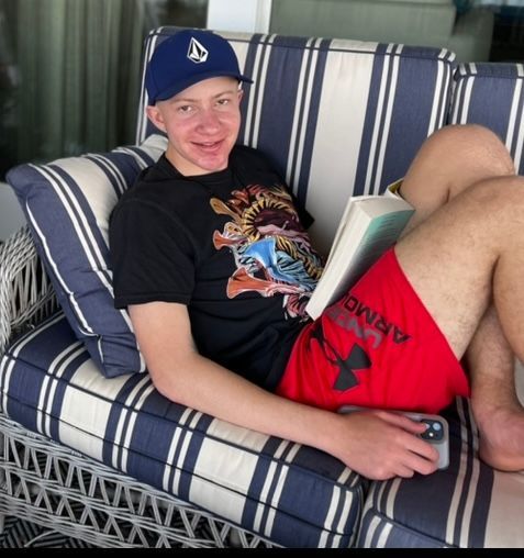 LBF Hero Ben Cortezi on the couch reading