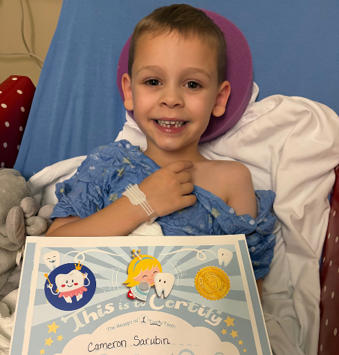 LBF Hero Cameron in hospital bed with certificate