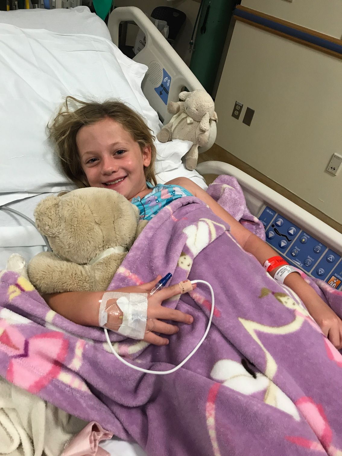 LBF Hero Maddie Highfill in hospital bed with teddy bear