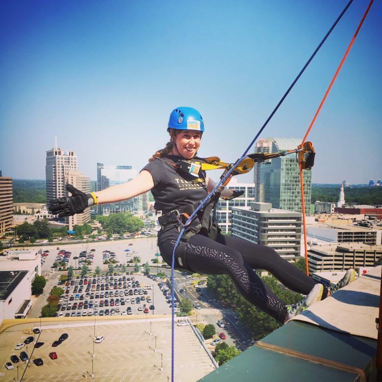 Nicole Giroux hanging off building