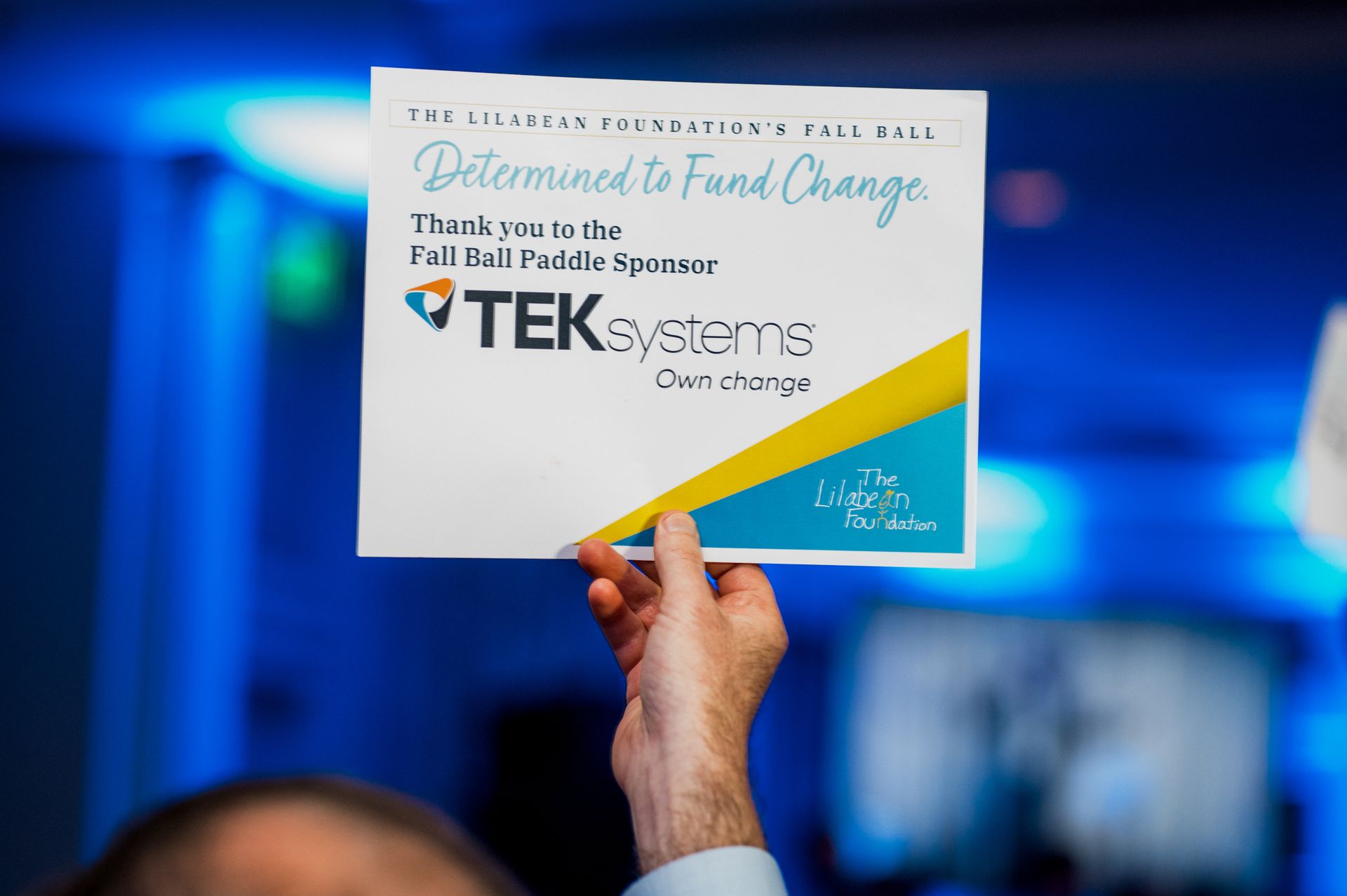 man holding certificate sponsored by TEK Systems