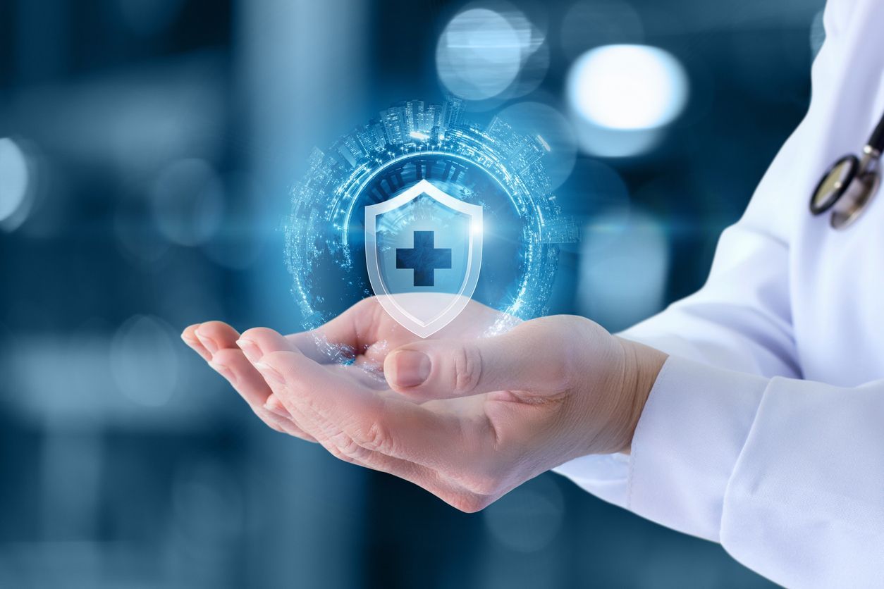 A doctor is holding a shield with a cross on it in his hands.