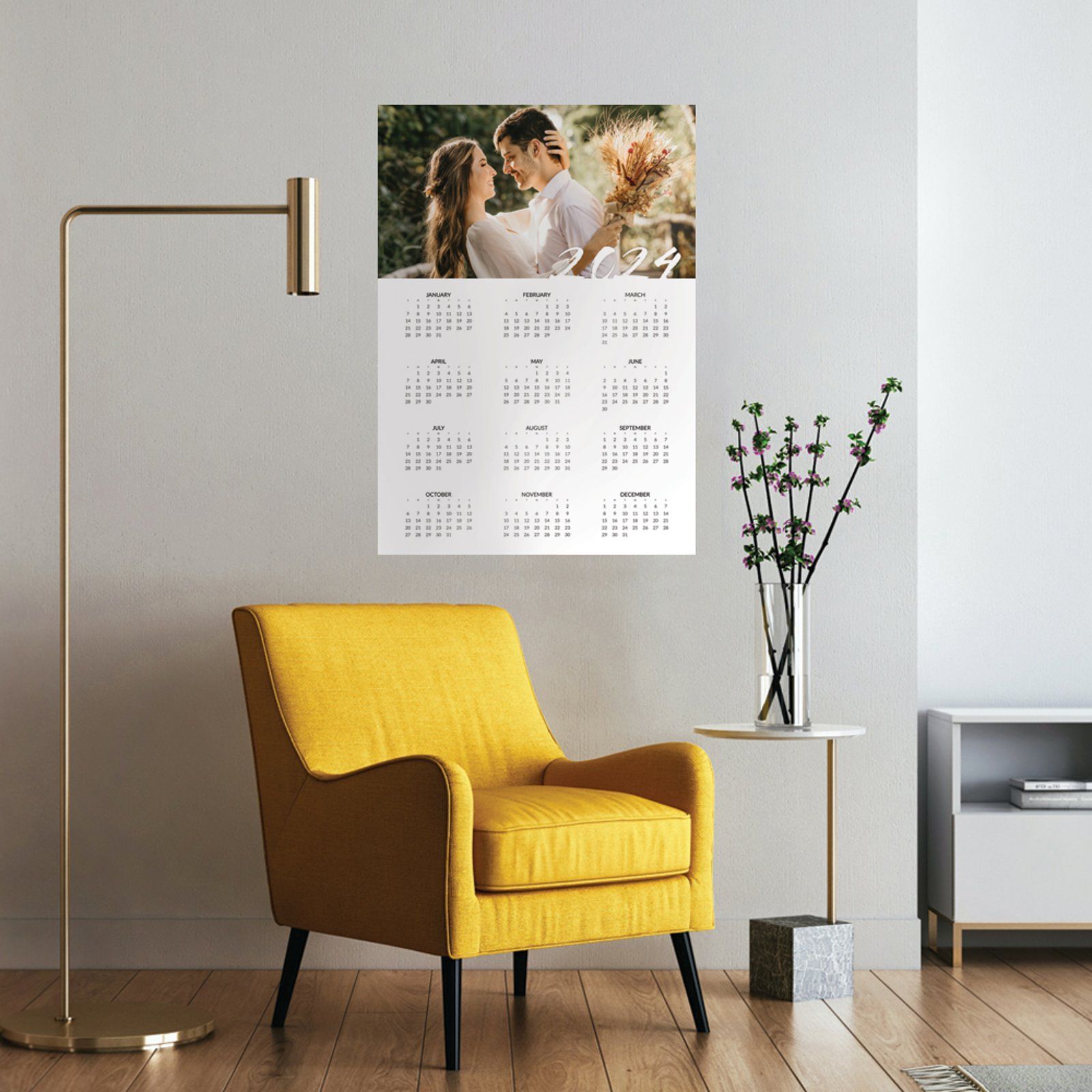 a living room with a yellow chair and a calendar on the wall .