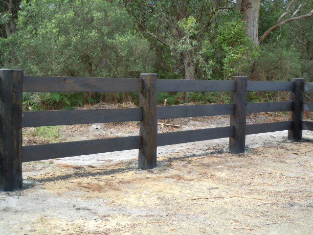 Black Wooden Fence — Professional Fencing in Taree, NSW