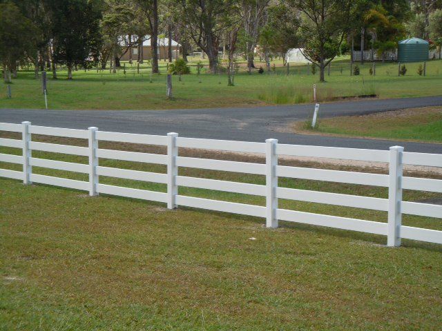 White Fence On Lawn — Professional Fencing in Taree, NSW