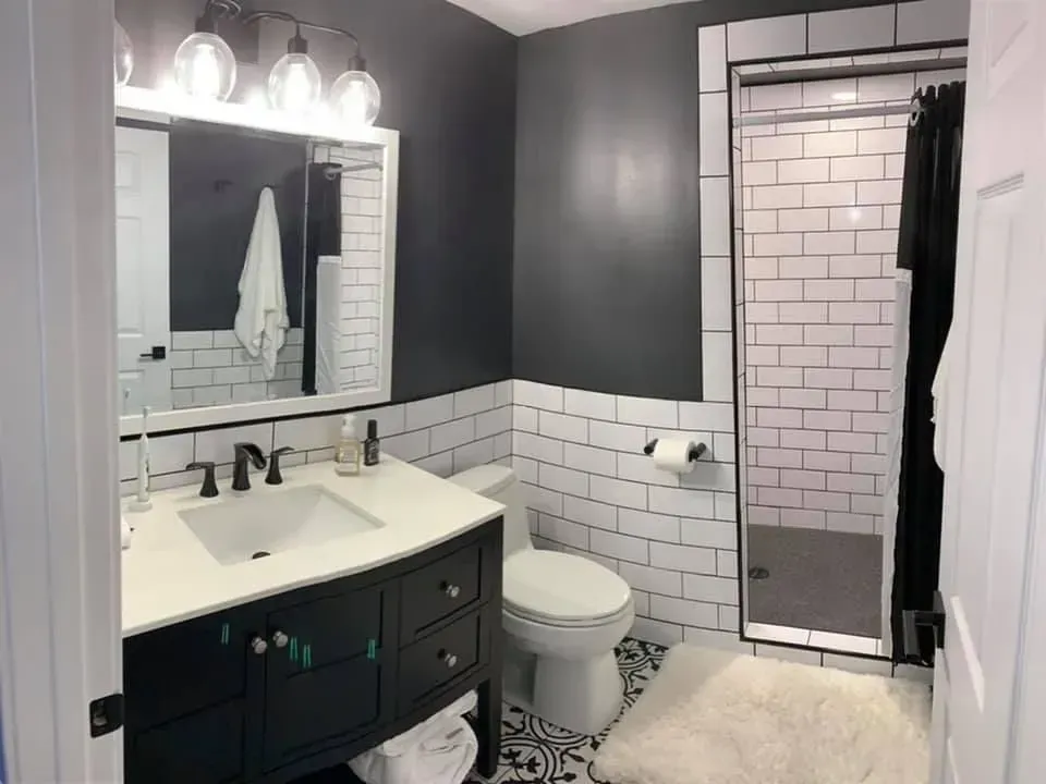 A bathroom with a sink , toilet , and shower.