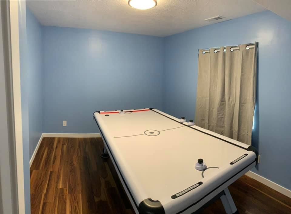 A room with a pool table and a window