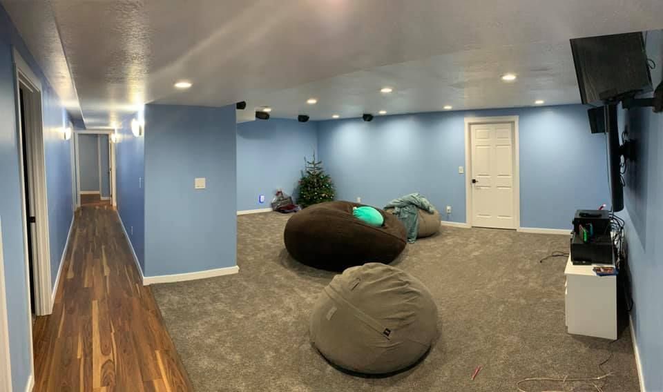 A large room with blue walls and a lot of bean bags on the floor.