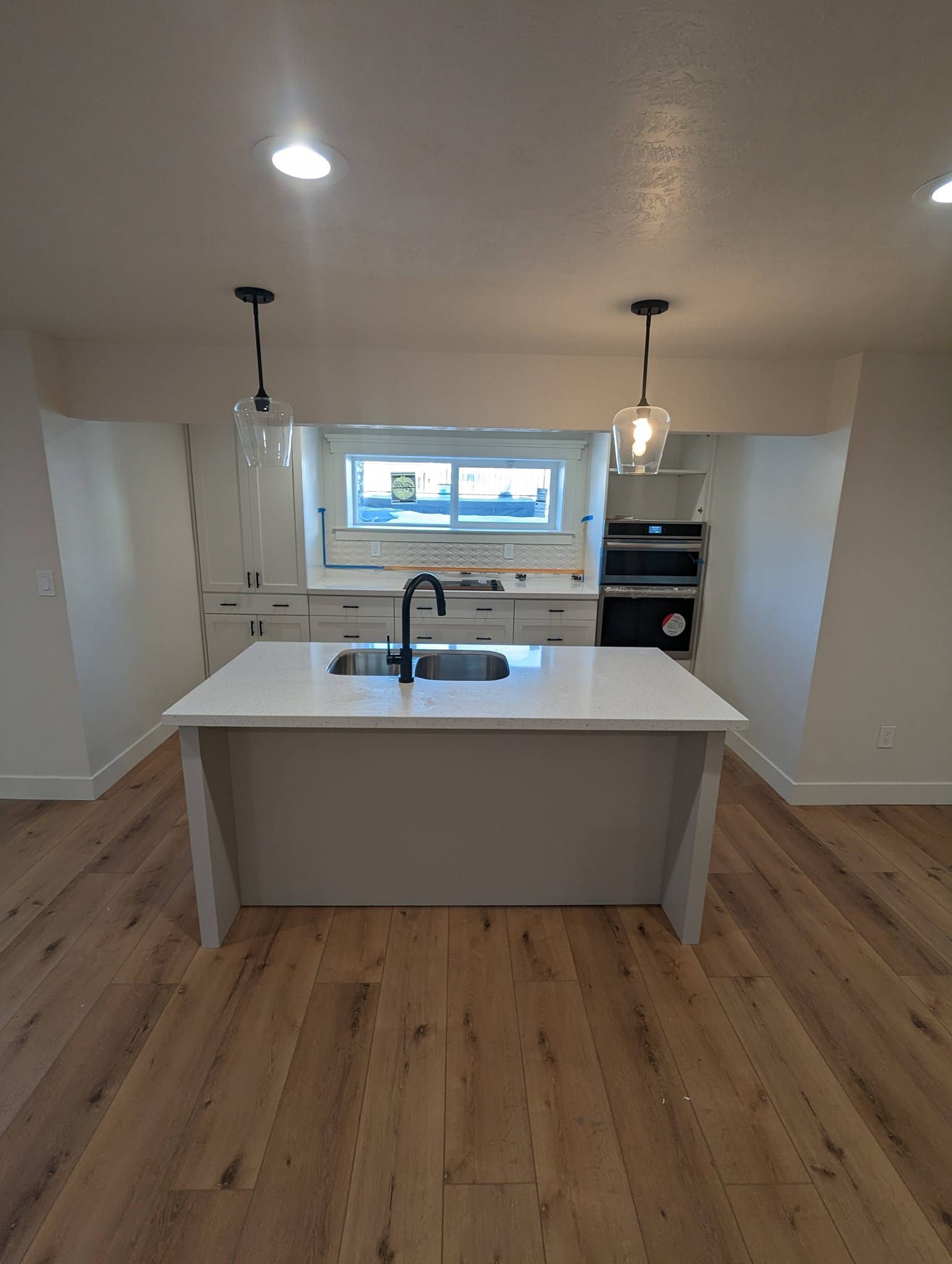 A kitchen with a large island and a sink.