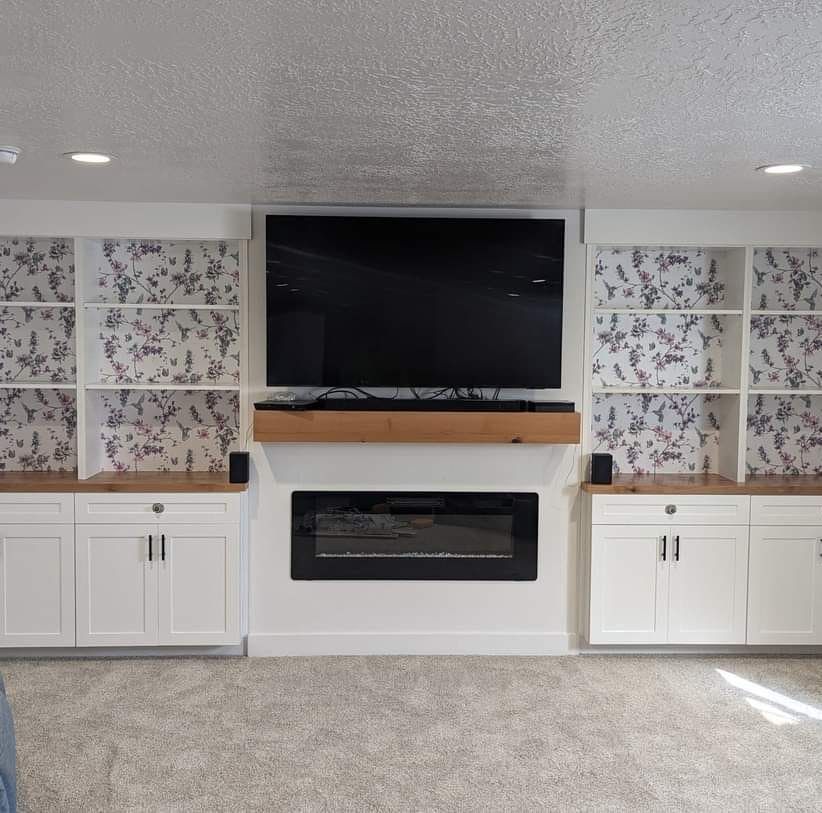 A living room with a fireplace and a flat screen tv