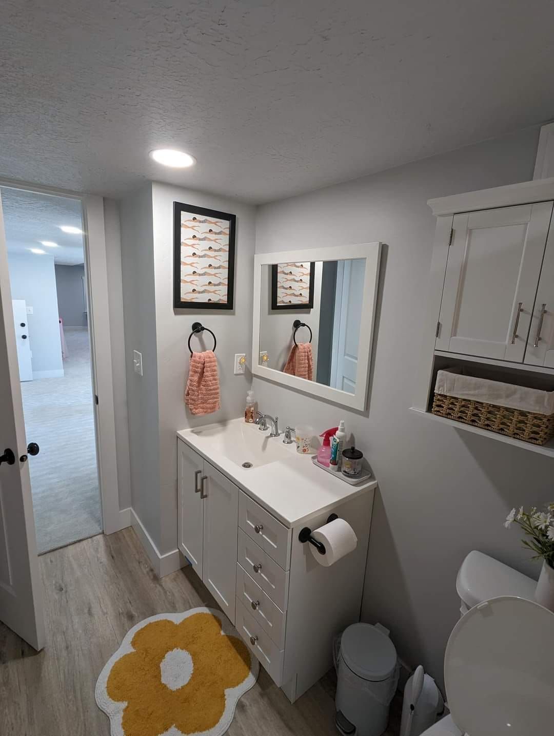 A bathroom with a sink , toilet , and mirror.