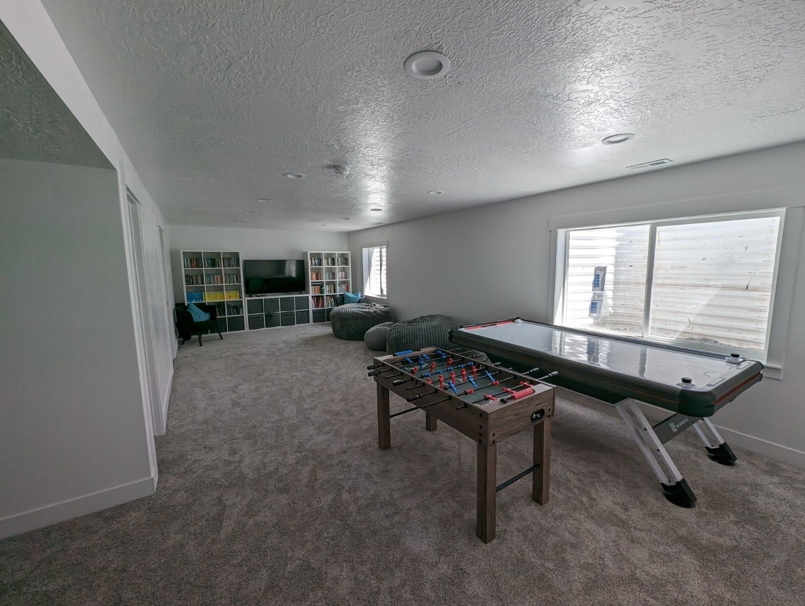 There is a game table in the middle of the room.